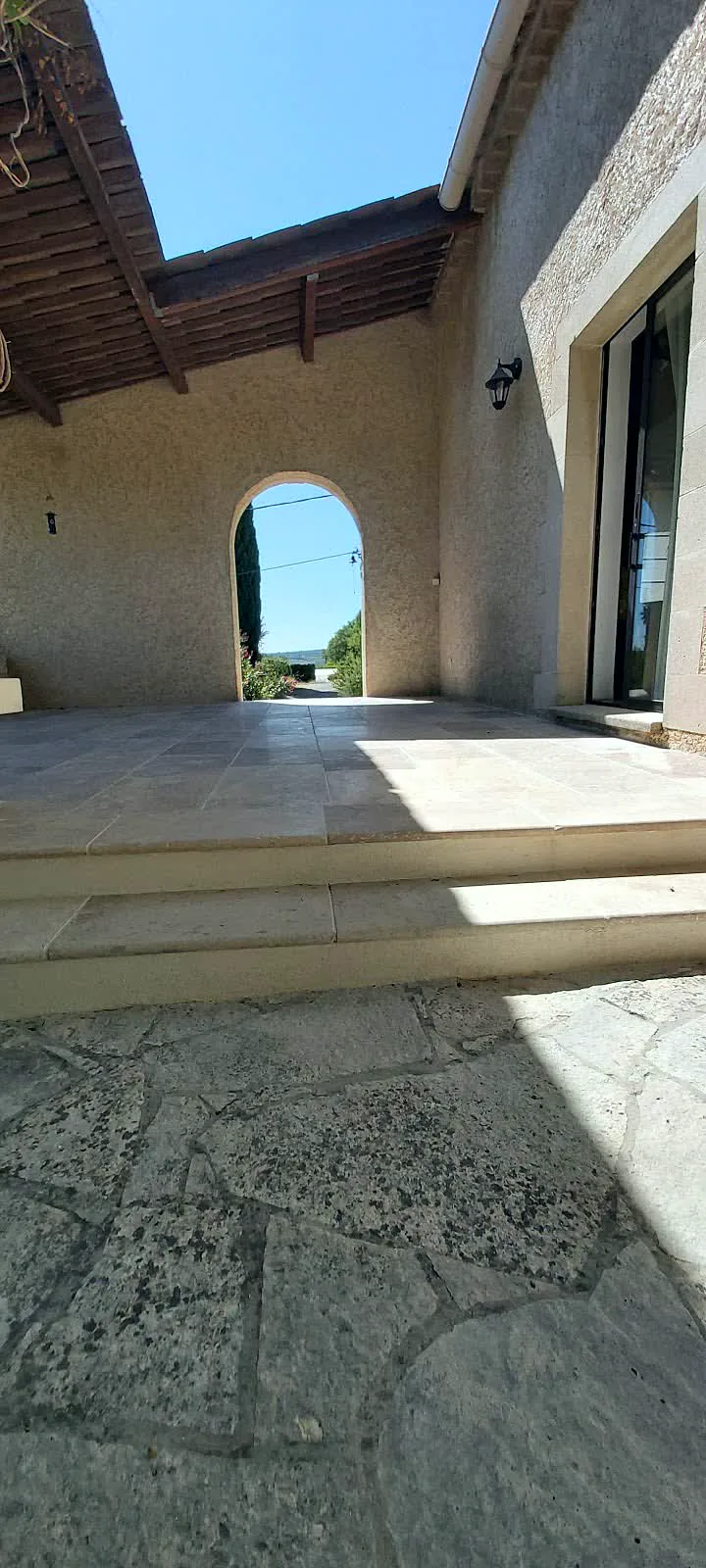 Terrasse en pierre sous une arche maçonnée